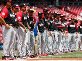 The World Team looks on during the national anthem prior to the All-Star Futures Game against the U.S. Team in Cincinnati. (AFP)