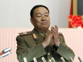 This July 18, 2012, file photo shows Vice Marshal Hyon Yong Chol applauding during a meeting announcing North Korean leader Kim Jong Un's new title of marshal, in Pyongyang, North Korea. North Korea has officially confirmed the purging of its defence chief two months after Seoul's spy service said he had been executed for disloyalty to leader Kim Jong Un, a South Korean official said Monday. (AP Photo/Jon Chol Jin, File)