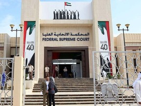 People stand outside the United Arab Emirates' Federal Supreme Court  in Abu Dhabi in this Nov. 27, 2011 file photo. REUTERS/Nikhil Monteiro