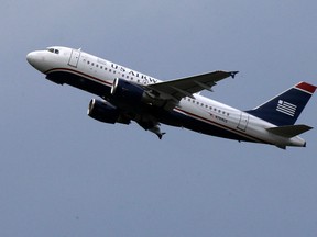 In this July 23, 2013, file photo, a US Airways jet takes off from Pittsburgh International Airport in Imperial, Pa. (AP Photo/Gene J. Puskar, File)