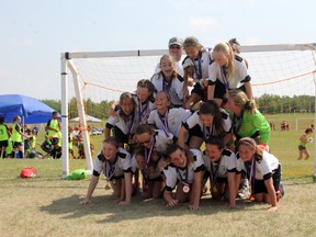 The U12 girls team attempts to create a pyramid following the team's silver medal win at provincials this past weekend.