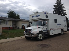 Homicide investigators gather evidence at the scene of a shooting at 49 Avenue and 111A Street that left a 27-year-old woman dead on Sunday, July 12, 2015. David Bloom/Edmonton Sun