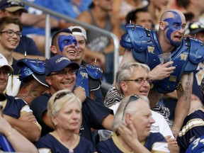 Bombers fans celebrate during the team's 25-23 win over the Montreal Alouettes on Friday night. There were some 8,000 empty seats for the game.