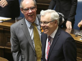 Finance Minister Greg Dewar (left) and Premier Greg Selinger smiled after delivering the provincial budget in April. It was that budget that prompted Moody's to downgrade Manitoba's credit rating. (Brian Donogh/Winnipeg Sun file photo)