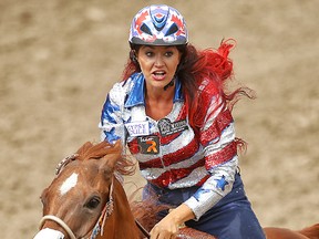 Fallon Taylor of Whitesboro, Texas, wife of RedBlacks kicker Delbert Alvarado, during the barrel racing event at the Calgary Stampede rodeo in Calgary, Alta. on Saturday July 4, 2015. Al Charest/Calgary Sun/Postmedia Network