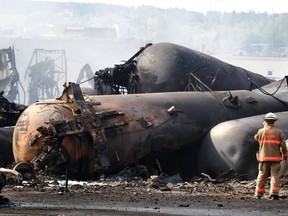 A firefighter works on the scene of a train derailment in Lac Megantic, Quebec, in this July 7, 2013 file photo. On Monday, a Quebec judge rejected Canadian Pacific Railway Ltd.'s challenge to a settlement for victims of the Lac-Megantic crude-by-rail disaster. REUTERS/Christinne Muschi/Files