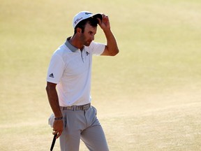 Dustin Johnson of the United States walks off the 18th green after making par during the final round of the 115th U.S. Open Championship at Chambers Bay on June 21, 2015. (Mike Ehrmann/Getty Images/AFP)