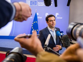 Greek Prime Minister Alexis Tsipras speaks with the media after a meeting of eurozone heads of state at the EU Council building in Brussels on Monday, July 13, 2015.  A summit of eurozone leaders reached a tentative agreement with Greece on Monday for a bailout program that includes "serious reforms" and aid, removing an immediate threat that Greece could collapse financially and leave the euro. (AP Photo/Geert Vanden Wijngaert)