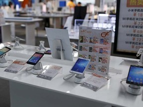 Mobile phones are seen on display at an electronics market in Shanghai, China, June 24, 2015. REUTERS/Aly Song