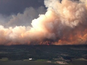 Smoke rises from a 7,000 hectare (17,000 acre) fire on the north side of Puntzi Lake, British Columbia in a picture release by the BC Wildfire Service July 11, 2015. The area is subject to an evacuation order. REUTERS/BC Wildfire Service/Handout via Reuters