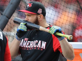 Blue Jays catcher Russell Martin kisses his bat during batting practice in Cincinnati yesterday. Martin signed a five-year contact with the Jays in the off-season. (AP)