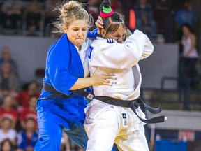 Canadian Kelita Zupancic (left) grapples with Onix Cortes of Cuba during their gold-medal judo match at the Pan Am Games on Monday night at the Mississauga Sports Complex. (Ernest Doroszuk/Toronto Sun)