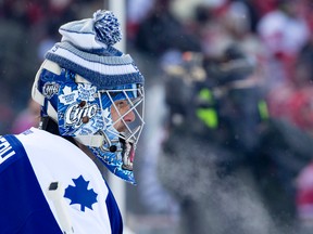 Former Toronto Maple Leafs goaltender Curtis Joseph keeps wears a toque to keep warm during the warmup before their game against the Detroit Red Wings during their Alumni Showdown hockey game Dec.31, 2013. CRAIG GLOVER/QMI Agency