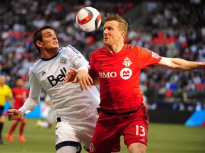 Vancouver Whitecaps forward Octavio Rivero (29) battles for the ball against Toronto FC defender Steven Caldwell (13) during the first half at BC Place. Anne-Marie Sorvin-USA TODAY Sports