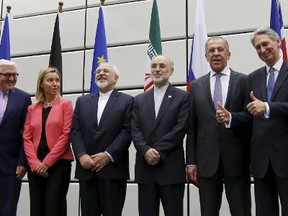 From left to right: Chinese Foreign Minister Wang Yi, French Foreign Minister Laurent Fabius, German Foreign Minister Frank Walter Steinmeier, European Union High Representative for Foreign Affairs and Security Policy Federica Mogherini, Iranian Foreign Minister Mohammad Javad Zarif, Head of the Iranian Atomic Energy Organization Ali Akbar Salehi, Russian Foreign Minister Sergey Lavrov, British Foreign Secretary Philip Hammon, U.S. Secretary of State John Kerry and U.S. Secretary of Energy Ernest Moniz pose for a group picture at the United Nations building in Vienna, Austria July 14, 2015. REUTERS/Carlos Barria