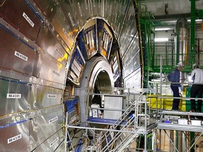 Technicians are seen working in the Compact Muon Solenoid (CMS) experiment, part of the Large Hadron Collider (LHC), during a media visit to the Organization for Nuclear Research (CERN) in the French village of Cessy, near Geneva in Switzerland, July 23, 2014. REUTERS/Pierre Albouy