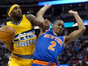 Denver Nuggets Ty Lawson (L) is fouled by New York Knicks Langston Galloway during their NBA basketball game in Denver, Colorado March 9, 2015. REUTERS/Mark Leffingwell