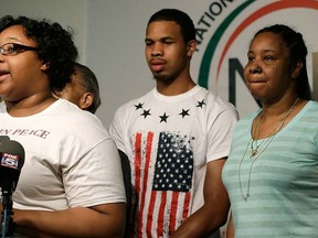 Eric Garner's daughter Emerald Snipes, left, is joined by her brother Eric Garner, centre,  and mother Esaw Snipes, as she speaks during a news conference, Tuesday, July 14, 2015, in New York.  (AP Photo/Mary Altaffer)