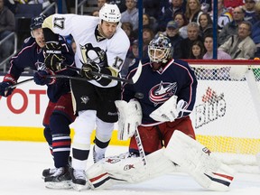 Pittsburgh Penguins left wing Taylor Pyatt (17) battles for the puck with Columbus Blue Jackets defenseman Jack Johnson (7) and goalie Curtis McElhinney (31) at Nationwide Arena on March 8, 2014. The big winger announced his retirement from the game Monday.