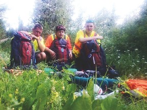 Three skateboarders are riding across British Columbia to raise money and awareness for the Ronald McDonald House charity. From left to right: Mike Hay, Easton Hay, Kieth Green look at some of the gear they have to leave behind on their journey to lighten their packs. Facebook photo.