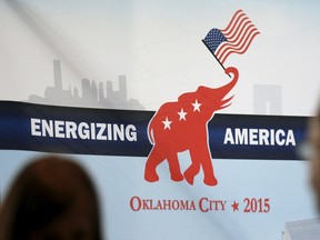 Attendees look at a banner at the Southern Republican Leadership Conference in Oklahoma City, Oklahoma on May 21, 2015. The Oklahoma Republican Party on Tuesday removed a Facebook post that compared people who receive food stamps to animals. REUTERS/Rick Wilking