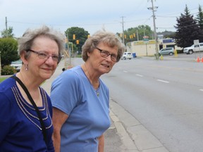 Pat DaSliva (left) and Margaret O'Neil try to cross at College Street West Tuesday afternoon outside Amica at Quinte Gardens Retirement Residence. Both women are on the home's resident council, which is pushing for a crosswalk outside of the home.