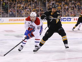 Michael Bournival (left) of the Montreal Canadiens skates away from Gregory Campbell of the Boston Bruins during NHL play at TD Garden on February 8, 2015 in Boston. (Maddie Meyer/Getty Images/AFP)