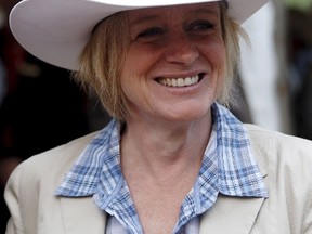 Alberta Premier Rachel Notley tries on her new Smithbilt cowboy hat after being white hatted at her premier's Stampede breakfast during the Calgary Stampede in Calgary, Alberta, July 6, 2015. REUTERS/Todd Korol