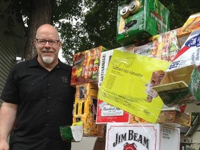 George McRobb, whose troupe will perform at the Duke of Kent Legion, poses next to his cardboard robot that will stand in the Exchange to promote the show, in lieu of making a sandwich board July 14, 2015. (David Larkins/Winnipeg Sun)