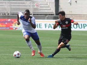 FC Edmonton defender Eddie Edward fends off San Antonio's Christain Palomeque during their NASL game in Fort McMurray (Robert Murray, Postmedia Network).