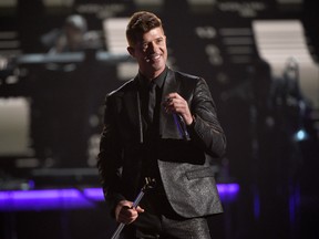 In this Sunday, June 28, 2015 file photo, Robin Thicke performs during a tribute to Smokey Robinson at the BET Awards at the Microsoft Theater in Los Angeles. A federal judge in Los Angeles on Tuesday, July 14, 2015, trimmed a copyright infringement verdict against Thicke and Pharrell Williams over their 2013 hit "Blurred Lines" from nearly $7.4 million to $5.3 million. The ruling also gives Marvin Gaye's family, which sued the singers over the song, an ongoing shared of royalties from "Blurred Lines."  (Photo by Chris Pizzello/Invision/AP, File)