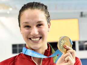 Chantal Van Landeghem, of Canada, smiles as she wears her gold medal after winning the women's 100m freestyle at the 2015 Pan Am Games in Toronto on Tuesday, July 14, 2015. THE CANADIAN PRESS/Frank Gunn