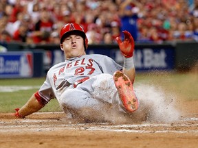 American League all-star Mike Trout of the Los Angeles Angels slides home to score at the Great American Ball Park in Cincinnati last night. Trout was named MVP of the game. (Getty Images/AFP)