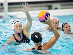 Kaleigh Gilchrest, left, of the USA, defends against Shae Fournier of Canada during the women's water polo gold medal match at the 2015 Pan Am Games in Markham, Ont. on Tuesday, July 14, 2015. The USA defeated Canada to win gold. THE CANADIAN PRESS/Darren Calabrese