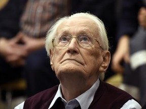 Former SS sergeant Oskar Groening, 94, looks up as he listens to the verdict of his trial Wednesday, July 15, 2015, at a court in Lueneburg, northern Germany. Groening, who served at the Auschwitz death camp was convicted on 300,000 counts of accessory to murder and given a four-year sentence. (Tobias Schwarz/Pool Photo via AP)