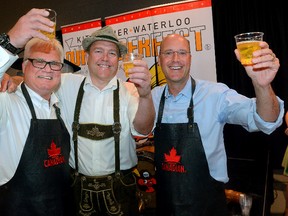 From left: Hugh Mitchell, CEO of Western Fair District, Alfred Lowrick, president of the Kitchener-Waterloo Octoberfest, and London Mayor Matt Brown toast the news that Octoberfest Festival will be expanding to London this fall during a press conference at the Western Fair Agriplex on Wednesday. (MORRIS LAMONT, The London Free Press)