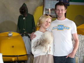 Chantelle and B.J. White stand beside the old snowmobiles currently on display at the Polar Bear Trading Post.