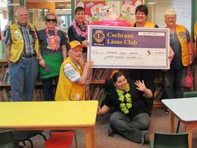 Representatives from the Cochrane Lions Club, Library staff and patrons gather to acknowledge the service club’s contribution to the summer reading program.