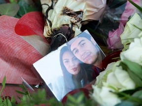 FIIn this July 20, 2014, file photo, a picture of Bryce Fredriksz and his girlfriend Daisy Oehlers who died on flight MH17, is surrounded by flowers at Schiphol airport in Amsterdam. On their son Bryce’s birthday this year, Silene Fredriksz-Hoogzand and her husband Rob went to a Dutch military airbase, watched pall bearers solemnly unload coffins from a cargo plane and wondered if they contained parts of the remains of Bryce or Daisy. AP Photo/Patrick Post, File