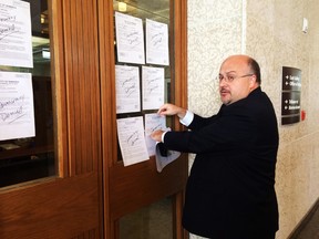 Coun. Russ Wyatt (Transcona) posts 21 cycling strategy-related motions on Mayor Brian Bowman's door, with "democracy denied" written on them.