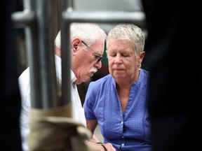 John and Mary Lyon, parents of missing sisters Katherine and Shelia, listen during a news conference in Wheaton, Md., Wednesday, July 15, 2015. Authorities on Wednesday announced first-degree murder charges against an imprisoned sex offender, bringing some clarity to the baffling case that made parents question whether to allow children out of their homes alone. AP Photo/Molly Riley
