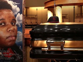 A baseball cap and a portrait of Michael Brown is shown alongside his casket inside Friendly Temple Missionary Baptist Church before the start of funeral services in St. Louis, Mo., Aug. 25, 2014.  REUTERS/Robert Cohen/Pool