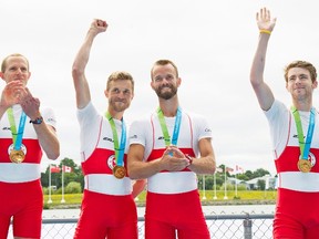 Members of Canada's men's lightweight coxless four, from left, Eric Woelfl, Nicolas Pratt of Kingston, Brendan Hodge and Maxwell Lattimer celebrate winning a gold medal at the 2015 Pan Am Games on the Royal Canadian Henley Rowing Course in St. Catharines, Ont., Wednesday. (Aaron Lynett/The Canadian Press)