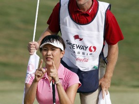 Amy Hung of Taiwan reads a putt with assistance from her caddy, Kurt Kowaluk, during first-round play at the LPGA Safeway Classic in North Plains, Ore., August 20, 2010. (REUTERS/Steve Dipaola)