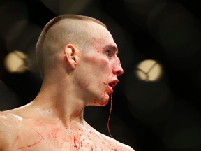 Blood drips from Rory MacDonald during his welterweight title bout against Robbie Lawler at the UFC 189 on July 11, 2015 in Las Vegas. (AP Photo/John Locher)