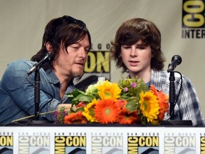 Actors Norman Reedus (L) and Chandler Riggs attend AMC's "The Walking Dead" panel during Comic-Con International 2014 at San Diego Convention Center on July 25, 2014 in San Diego, California.  Kevin Winter/Getty Images/AFP