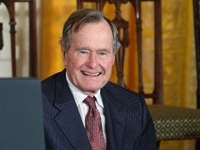 Former U.S. President George H.W. Bush waits to be awarded the Medal of Freedom by U.S. President Barack Obama during a ceremony at the White House in Washington in this February 15, 2011 file photo. Former U.S. President George H.W. Bush broke a bone in his neck during a fall at his home in Maine on July 15, 2015, spokesman Jim McGrath said.    REUTERS/Larry Downing/Files