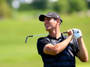 Canadian Garrett Rank follows his shot during a practice round yesterday at Angus Glen in Markham. Rank, who will be one of three Canadians in today’s Pan Am Games golf competition,  is also on the cusp of a career as an NHL referee, having worked nine games this past season. (DAVE ABEL, Toronto Sun)