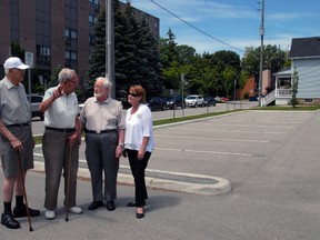 They may not look like street fighters, however Metcalfe Gardens residents Ray Scratch, left, Jim Cumming, Bill Pennings and general manager Lori Lackey - seen here standing in the nearly empty Crocker St. parking lot - have been battling the city for almost a year over restrictive parking measures in the courthouse area. Visitors to the retirement residence often have to park blocks away when coming to see friends and family.
