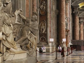 Priests wait to give confessions during the penitential celebration in the St. Peter's Basilica at the Vatican, in this March 13, 2015 file photo. (REUTERS/Alessandro Bianchi)